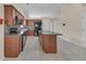 Modern kitchen with an island, sleek black appliances, and cherry wood cabinetry at 70 Prince Edward Way, Covington, GA 30016