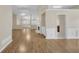 Open-concept living room with hardwood floors, fireplace, and neutral paint colors at 70 Prince Edward Way, Covington, GA 30016
