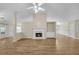 Spacious living room featuring hardwood floors, fireplace, and views to other rooms at 70 Prince Edward Way, Covington, GA 30016