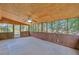 Relaxing sunroom with wood paneling, ceiling fan, and scenic backyard views at 70 Prince Edward Way, Covington, GA 30016