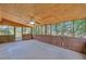 Relaxing sunroom with wood paneling, ceiling fan, and scenic backyard views at 70 Prince Edward Way, Covington, GA 30016