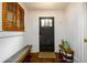 Inviting entryway with hardwood floors, a black front door, and a window with wooden shutters at 1448 N Highland Ne Ave, Atlanta, GA 30306