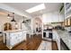 Updated kitchen with white cabinets, granite countertops, stainless steel appliances, a large island and skylight at 1448 N Highland Ne Ave, Atlanta, GA 30306