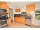 Well-equipped kitchen with stainless steel appliances, tile backsplash, and wood cabinets at 2172 Cold Springs Cir, Lithonia, GA 30058