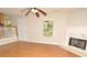 Bright living room with fireplace, fan, and wood floors at 2172 Cold Springs Cir, Lithonia, GA 30058