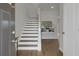 Welcoming entryway features hardwood floors, elegant staircase, and stylish console table with decorative accents at 2820 Aralynn Way, Atlanta, GA 30337