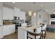 Contemporary kitchen with stainless steel appliances, a central island with seating, and modern pendant lighting at 2820 Aralynn Way, Atlanta, GA 30337