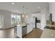 Bright kitchen featuring a large island, stainless steel appliances, and a dining area with abundant natural light at 2820 Aralynn Way, Atlanta, GA 30337