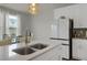 Bright kitchen island with stainless steel appliances, modern cabinetry and adjacent dining area with natural light at 2820 Aralynn Way, Atlanta, GA 30337