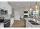Well-equipped kitchen featuring a stainless steel oven, and a view to a cozy living room with fireplace at 2820 Aralynn Way, Atlanta, GA 30337