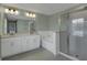 Spa-like bathroom boasts double vanity, garden tub, sleek glass shower, and modern fixtures at 2820 Aralynn Way, Atlanta, GA 30337
