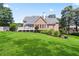 Large backyard with lush green lawn and a brick home with a white deck at 4759 Highland Point Dr, Auburn, GA 30011