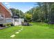 Expansive backyard with lush lawn, stepping stone pathway, and a spacious deck perfect for outdoor entertaining at 4759 Highland Point Dr, Auburn, GA 30011