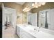 Bathroom featuring double sink vanity, large mirror, and views to rooms down the hall at 4759 Highland Point Dr, Auburn, GA 30011