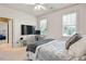 Bedroom featuring neutral walls, plush bedding, and a mounted flatscreen TV at 4759 Highland Point Dr, Auburn, GA 30011