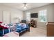 Bedroom with ceiling fan, two windows, and sports themed decor at 4759 Highland Point Dr, Auburn, GA 30011