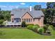 Charming two-story brick home featuring a spacious deck with outdoor seating and a well-manicured lawn and landscape at 4759 Highland Point Dr, Auburn, GA 30011
