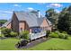 Stunning brick home featuring a spacious deck with outdoor seating, manicured lawn, and lush greenery at 4759 Highland Point Dr, Auburn, GA 30011