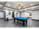 A large game room featuring a blue pool table, recessed lighting, and gray flooring at 4759 Highland Point Dr, Auburn, GA 30011