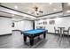 Finished game room with a pool table, seating, and modern gray wood-look flooring at 4759 Highland Point Dr, Auburn, GA 30011