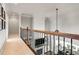 View from upstairs hallway of the open concept living room and dining area with white fireplace at 4759 Highland Point Dr, Auburn, GA 30011