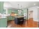 Spacious kitchen with a large island, stainless appliances, and custom green cabinetry at 4759 Highland Point Dr, Auburn, GA 30011