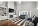 Spacious living room with a soaring ceiling, centered by a cozy fireplace and built-in shelving for a modern living space at 4759 Highland Point Dr, Auburn, GA 30011