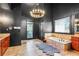 The luxurious bathroom featuring a soaking tub, vanity, chandelier and dark modern walls at 4759 Highland Point Dr, Auburn, GA 30011