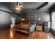 Stunning main bedroom features dark walls, tray ceilings, and a modern mini fridge for convenience at 4759 Highland Point Dr, Auburn, GA 30011