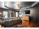 Spacious main bedroom featuring dark walls, hardwood floors, TV, ceiling fan and a large mirror at 4759 Highland Point Dr, Auburn, GA 30011