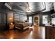 Spacious main bedroom featuring dark walls, hardwood floors, ceiling fan and a large mirror at 4759 Highland Point Dr, Auburn, GA 30011