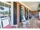 Cozy front porch with brick flooring and classic rocking chairs at 4759 Highland Point Dr, Auburn, GA 30011