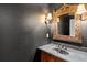 Stylish powder room featuring a decorative mirror and dark walls at 4759 Highland Point Dr, Auburn, GA 30011