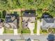 Aerial view showcasing the home's placement on a well-manicured lot, surrounded by mature trees and lush landscaping at 4771 Moon Chase Dr, Buford, GA 30519