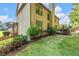 View of the backyard with a stone patio, wooden deck, and lush green lawn, perfect for outdoor entertaining at 4771 Moon Chase Dr, Buford, GA 30519