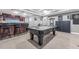 Basement with pool table, ping pong table, dark wood bar, and recessed lighting at 4771 Moon Chase Dr, Buford, GA 30519
