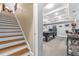 Basement area with stairs leading down to a rec room with a pool table and coffered ceiling at 4771 Moon Chase Dr, Buford, GA 30519