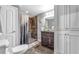 Bathroom with tile shower, granite vanity, and custom white cabinets at 4771 Moon Chase Dr, Buford, GA 30519