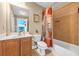 Bathroom featuring a shower with patterned curtains, a wooden cabinet and toilet at 4771 Moon Chase Dr, Buford, GA 30519