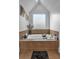 Bathroom featuring a tiled tub with a window at 4771 Moon Chase Dr, Buford, GA 30519