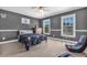 Spacious bedroom with gray walls, basketball hoop, and natural light from two windows at 4771 Moon Chase Dr, Buford, GA 30519