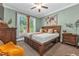 Cozy bedroom with a large window, ceiling fan, and natural light at 4771 Moon Chase Dr, Buford, GA 30519