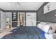 Bedroom with gray walls and doorway views of a hallway and bathroom at 4771 Moon Chase Dr, Buford, GA 30519