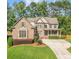 Charming brick two-story home with a manicured lawn and inviting front porch at 4771 Moon Chase Dr, Buford, GA 30519
