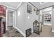 Hallway area with slate floors, decor, and a view into a room with white cabinets at 4771 Moon Chase Dr, Buford, GA 30519