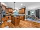 Spacious kitchen with wooden cabinets, granite countertops, island, and dining area access at 4771 Moon Chase Dr, Buford, GA 30519