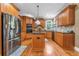 Bright kitchen featuring a kitchen island, stainless steel appliances, and hardwood floors at 4771 Moon Chase Dr, Buford, GA 30519
