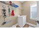 Well-organized laundry room featuring shelving, sink and convenient hanging space at 4771 Moon Chase Dr, Buford, GA 30519