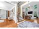 Bright living room with hardwood floors, staircase, fireplace, and large windows at 4771 Moon Chase Dr, Buford, GA 30519