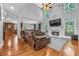 Spacious living room with a fireplace, hardwood floors and an open concept connecting to the kitchen at 4771 Moon Chase Dr, Buford, GA 30519